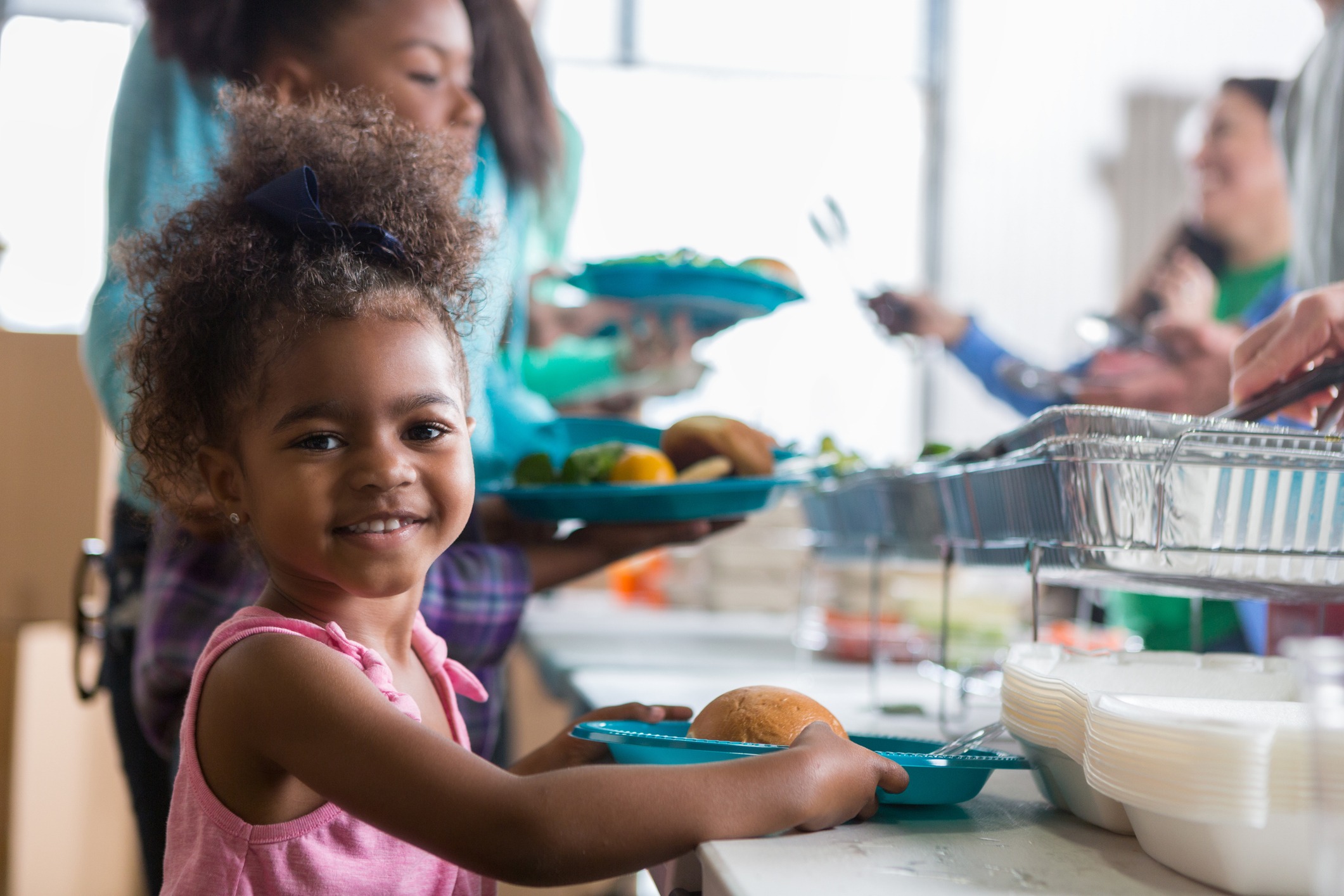 Preschool child getting food